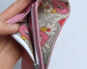 Pink leather wallet with 1950s floral lining, ID window and zip coin pocket.