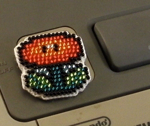 Fireflower pin, super mario video game