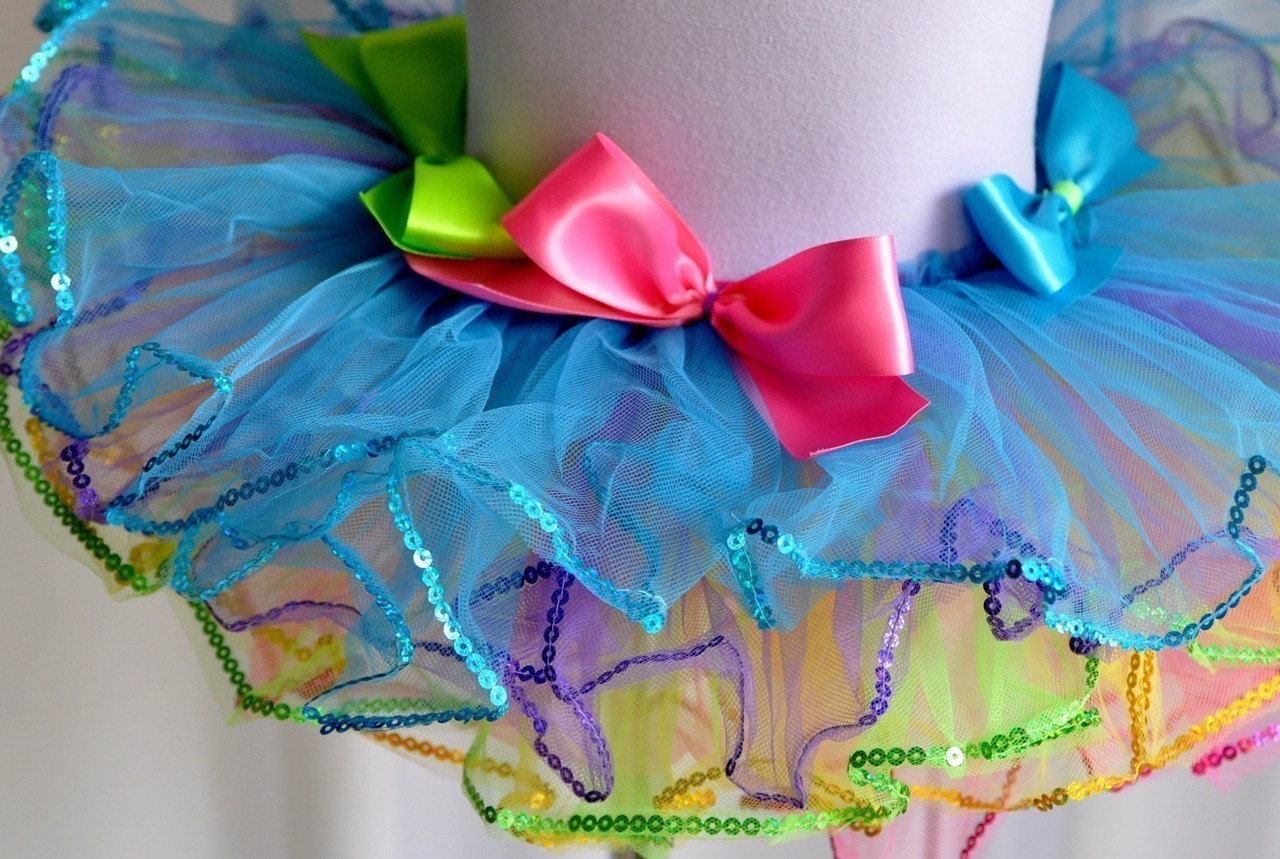 Pastel Rainbow Bright Tutu . Bows and edged in sequins. Reversible pink or aqua and ready to ship. Includes Bow Headband.