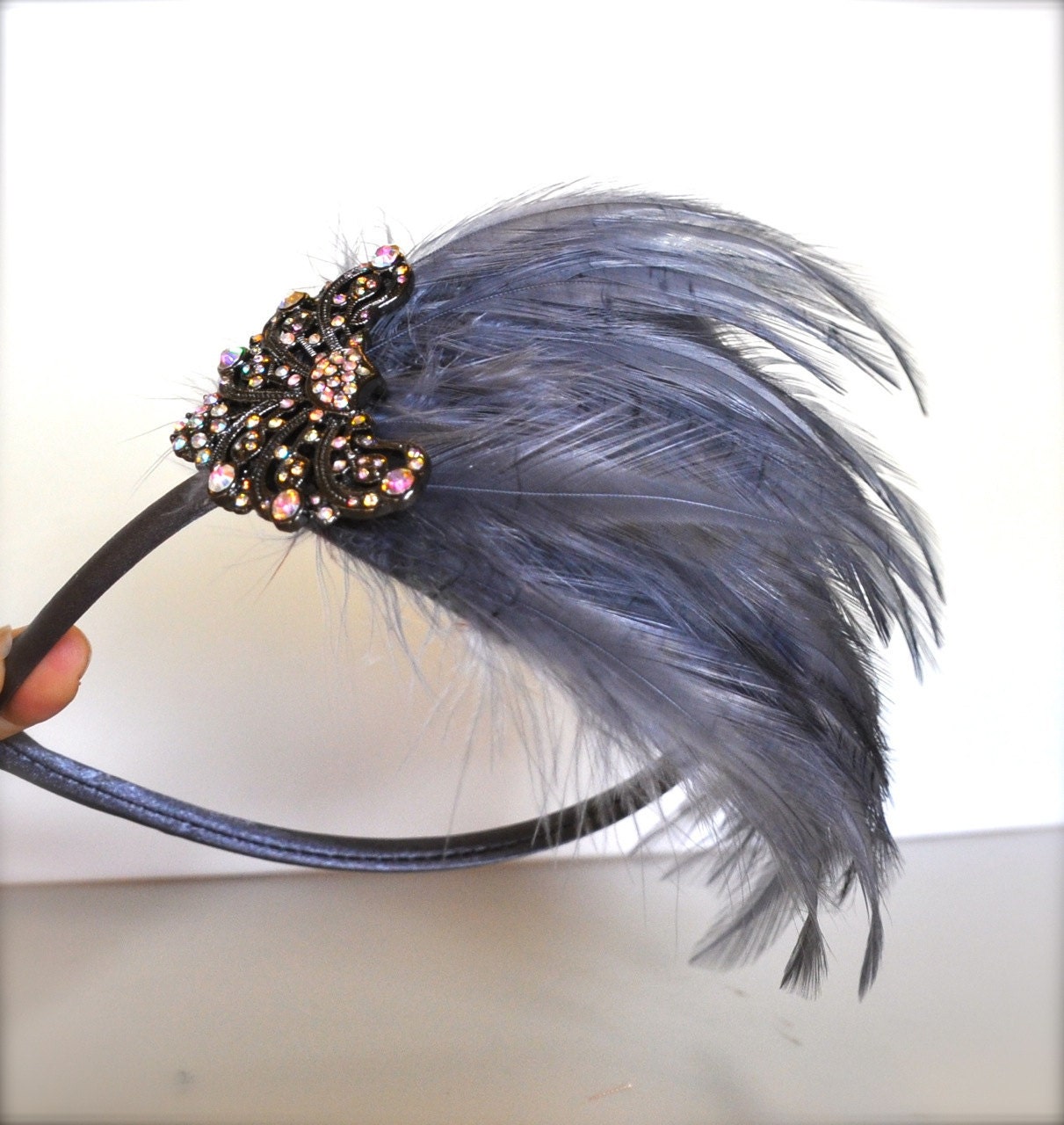 Victorian grey feather fascinator headband with elegant rhinestone piece.. A chic classic.