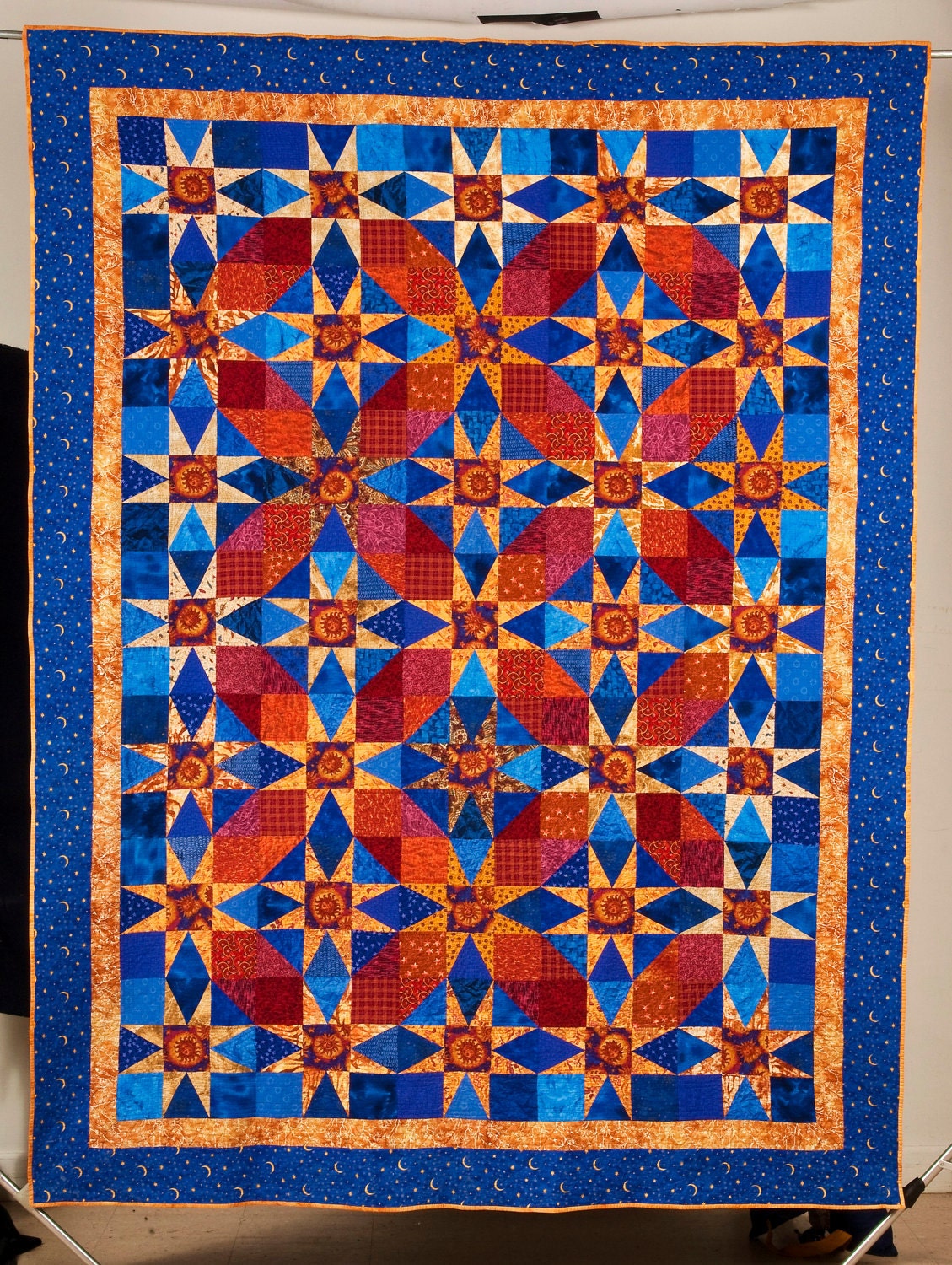 Quilt -- Gold Stars and Red "Circles" are Set against Cobalt Blue Background