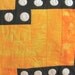 Quilt--Hot Colors of Yellow, Orange, Red and Pink Form the Background for a Black Maze with White Appliqued Circles