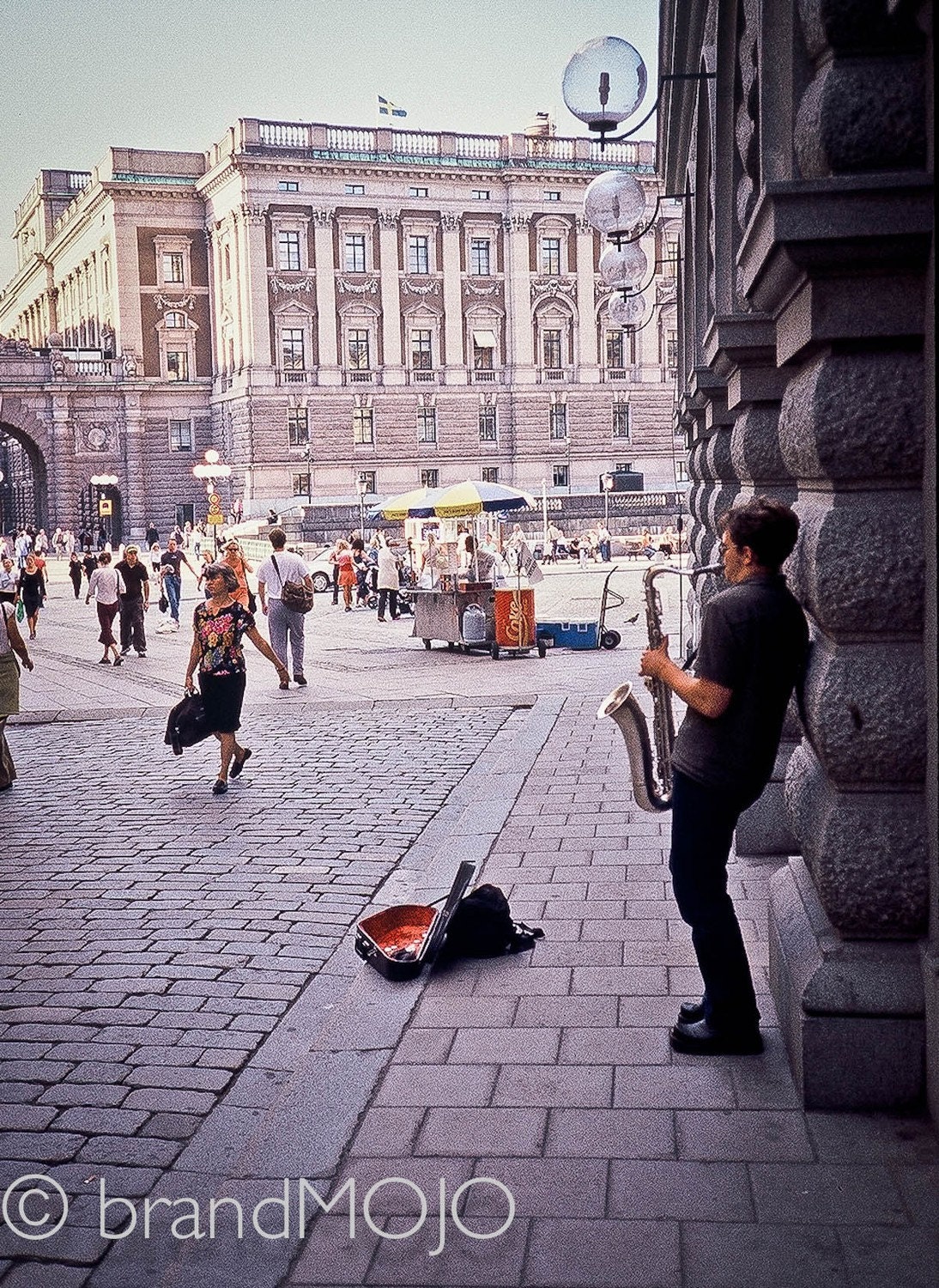 Urban life fine art photo walking street performer jazz saxophone stockholm sweden city life center town square Carrie likes a jazzman