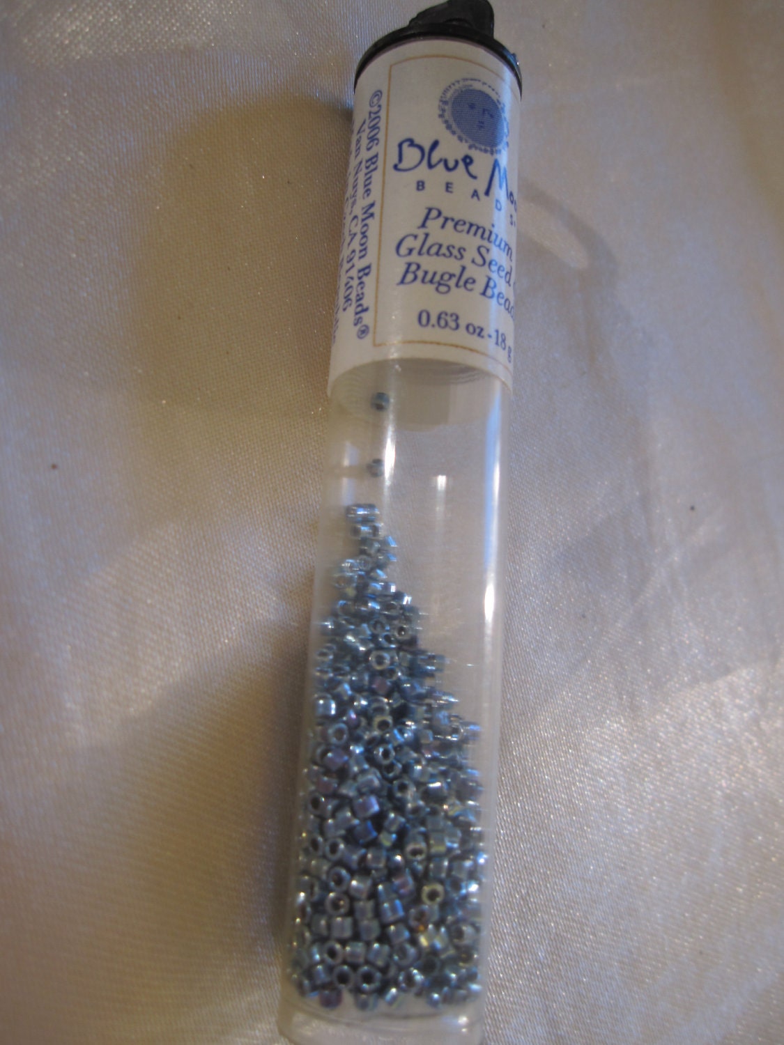 Destash bright shining grey blue glass seed beads.