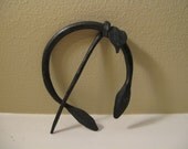 Forged brooch