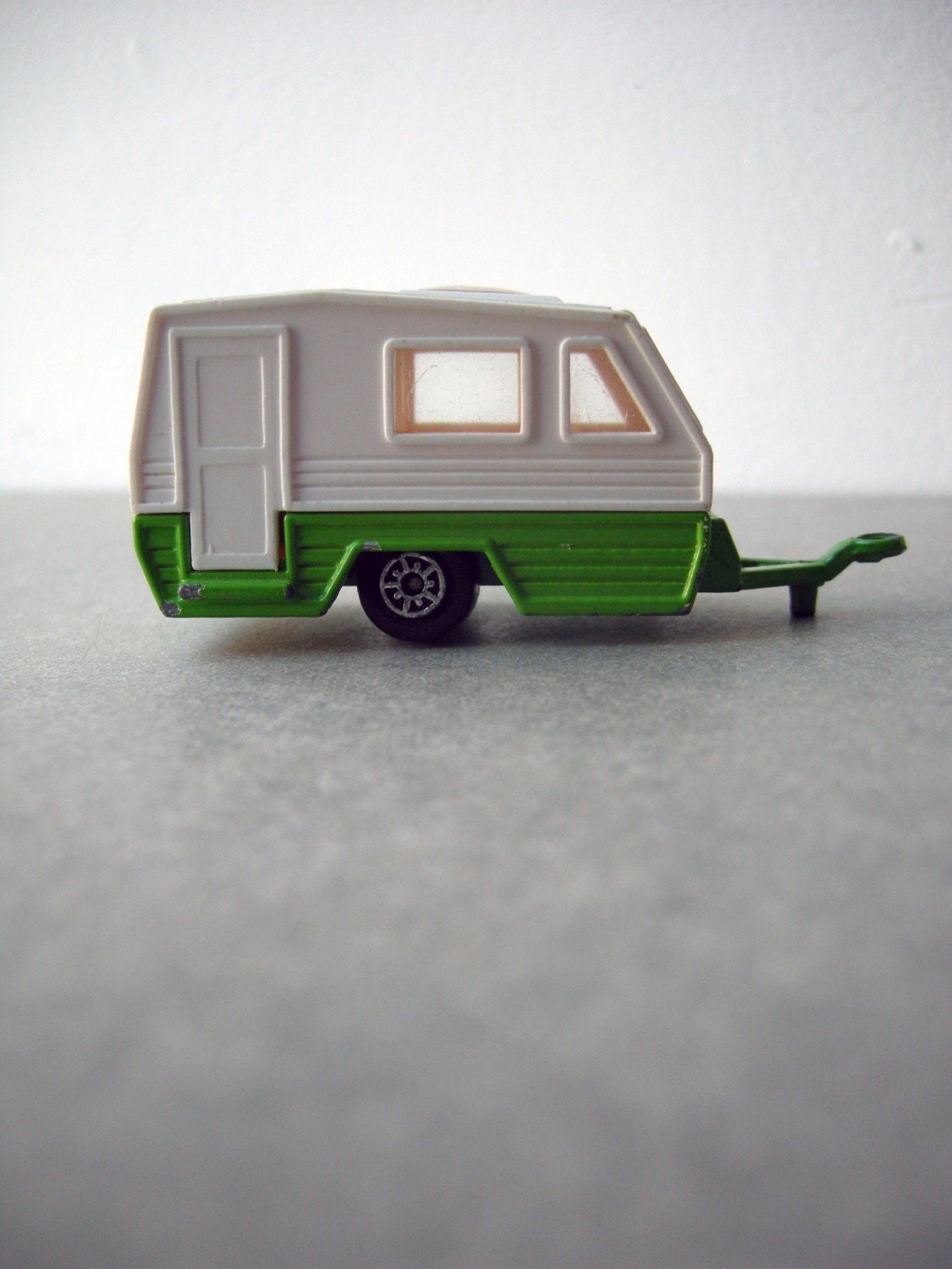 Green/white toy caravan