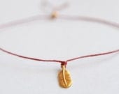 Gold Wish bracelet . Cutest gold feather charm red irish waxed linen cord