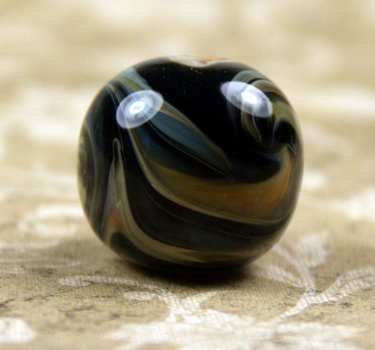 Bead with Swirls of Black, Tan, and Blue - joanlaessleart