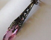 Pendant Large pink faceted cubic zirconia crystal in victorian cone wire wrapped copper on a copper chain 16 inches long with toggle clasp
