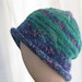 Knitted Beanie in Recycled Yarn in Blue and Green Stripes with Rolled Brim