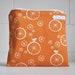 small wet bag. organic cotton. orange birdie spoke. waterproof.