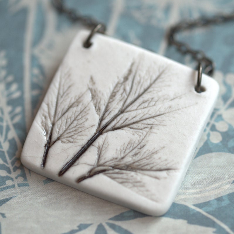 Earthy Porcelain Pendant with Impression of small leaves.