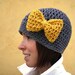 Minnie's Grey Crochet Hat with Bright Yellow Bow