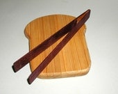 slice of bread board and toast tongs