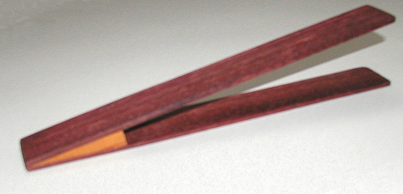 slice of bread board and toast tongs