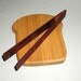 slice of bread board and toast tongs