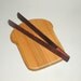 slice of bread board and toast tongs