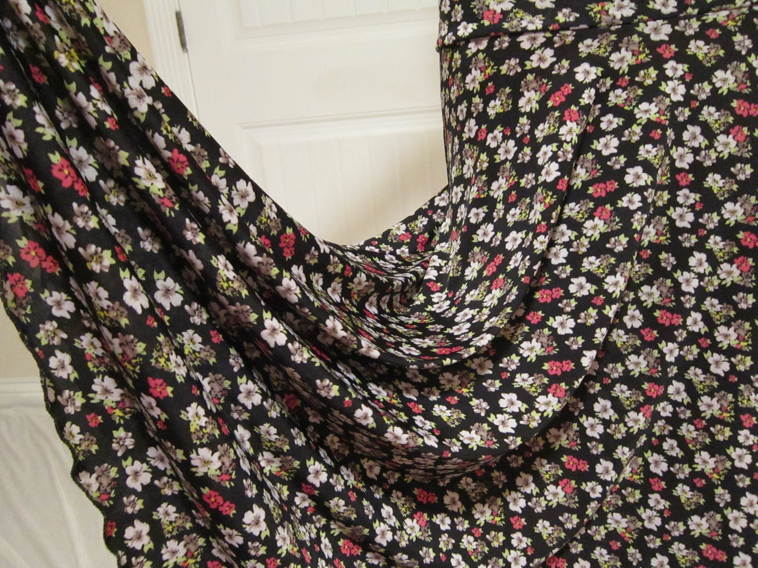 Lady's long, modest maxi knit missionary, travel or work skirt with tiny white and pink flowers on a black ground, size medium-large.