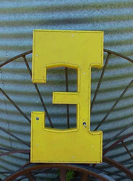 vintage yellow metal salvaged neon sign letter E