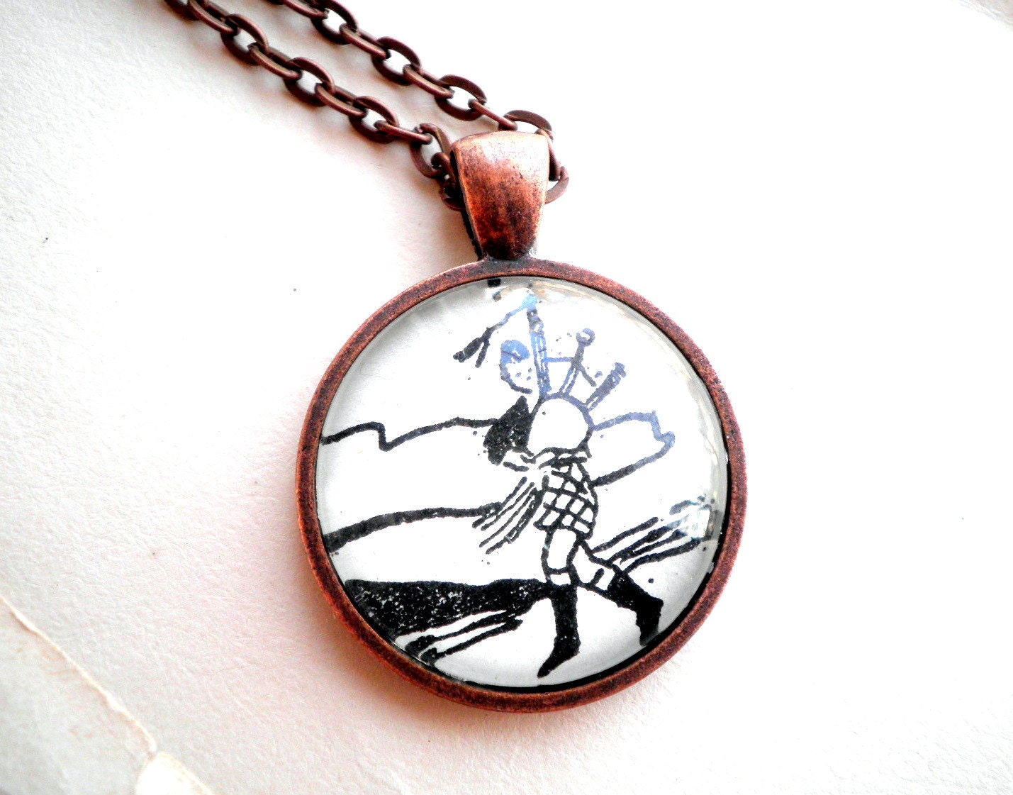 Bagpipe player necklace. Copper pendant with real vintage sheet music illustration under glass dome.