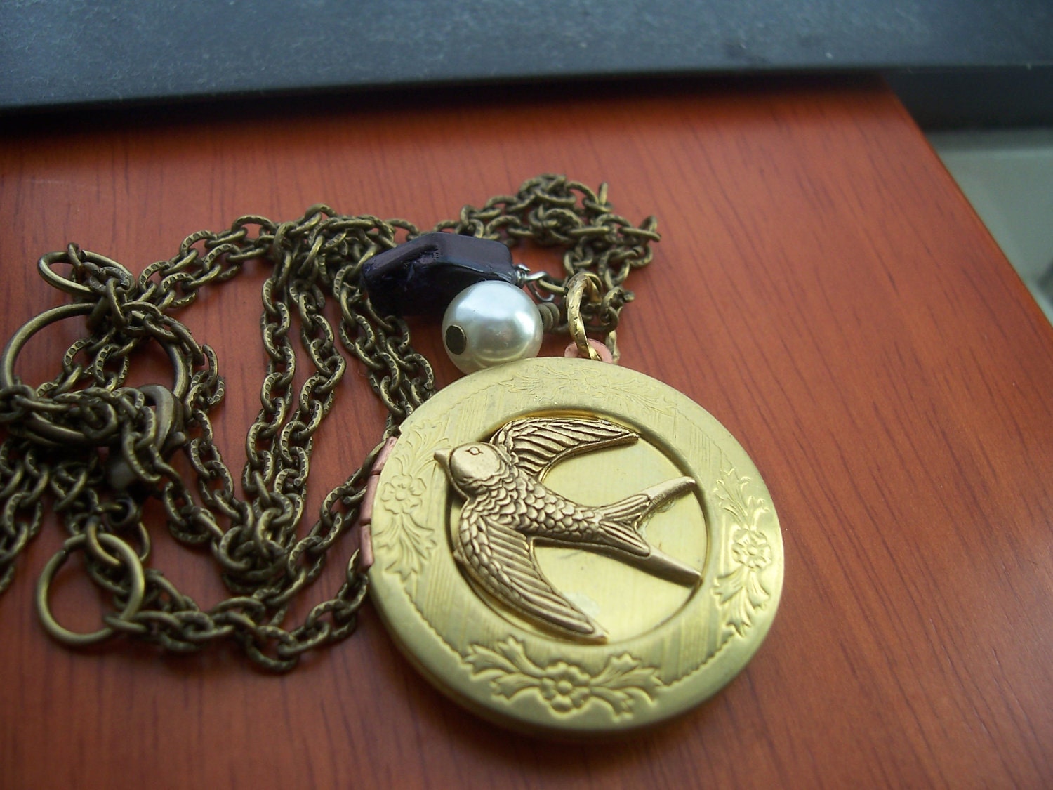 Hunger Games Necklace - Peeta's locket  with  Mockingjay -pearl and coal