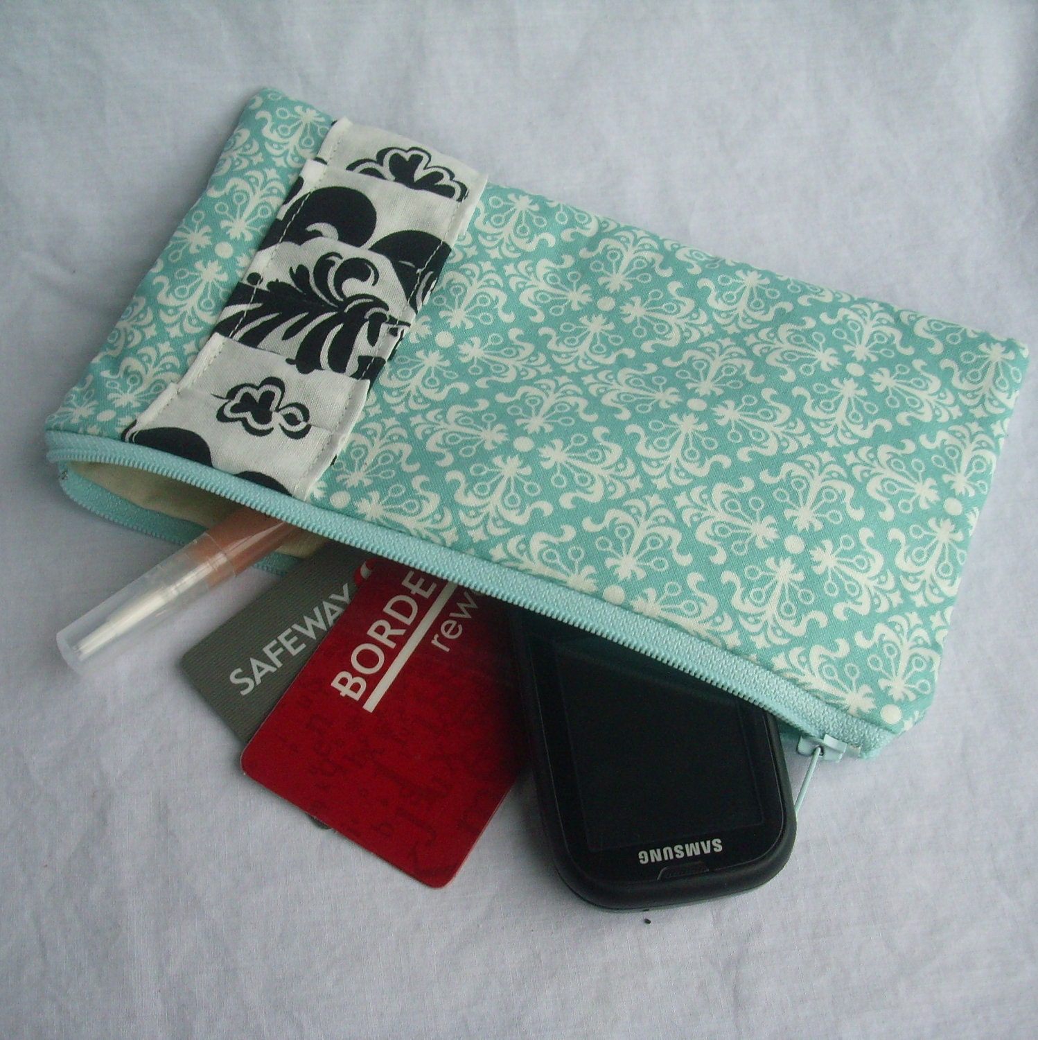 Turquoise Patterned Clutch with White and Black Pleated Accent