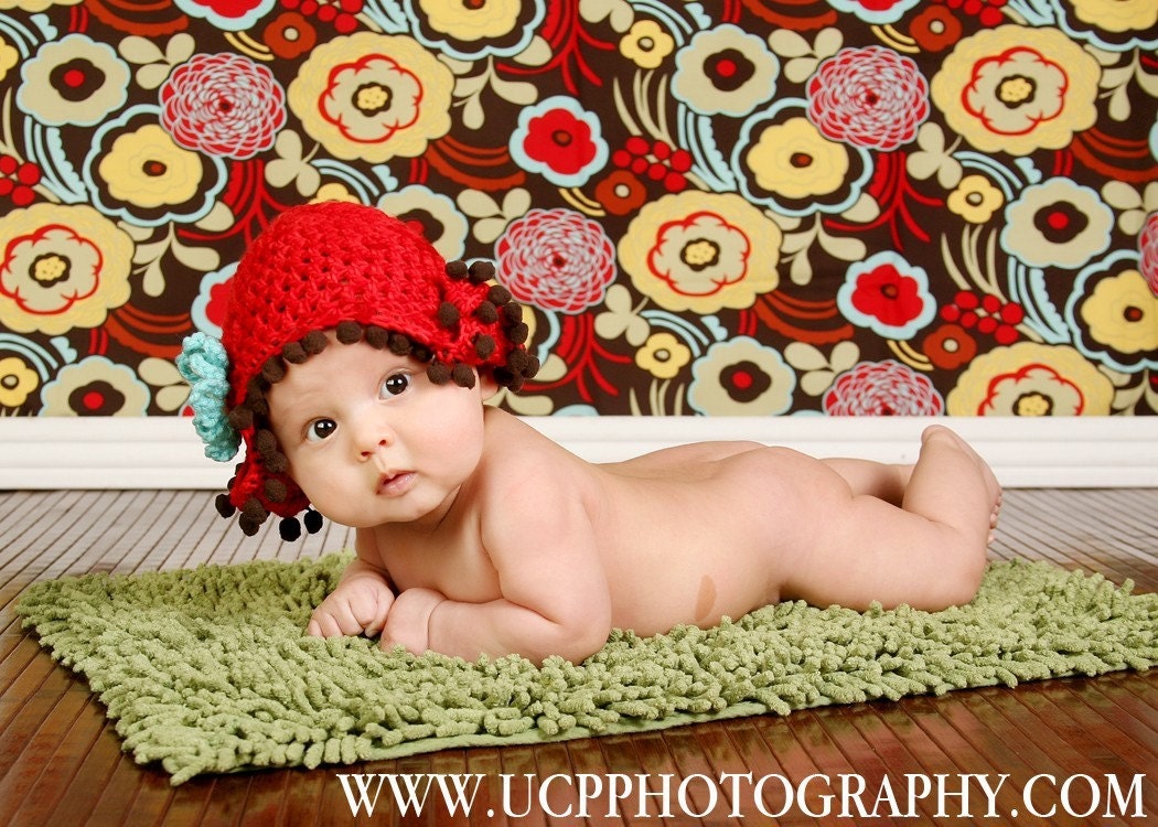 Newborn  Adorable Red Elf Hat with brown pom pom trim and turquoise and yellow flower