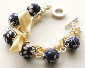 Yellow satin ribbon and dark blue fabric beads bracelet