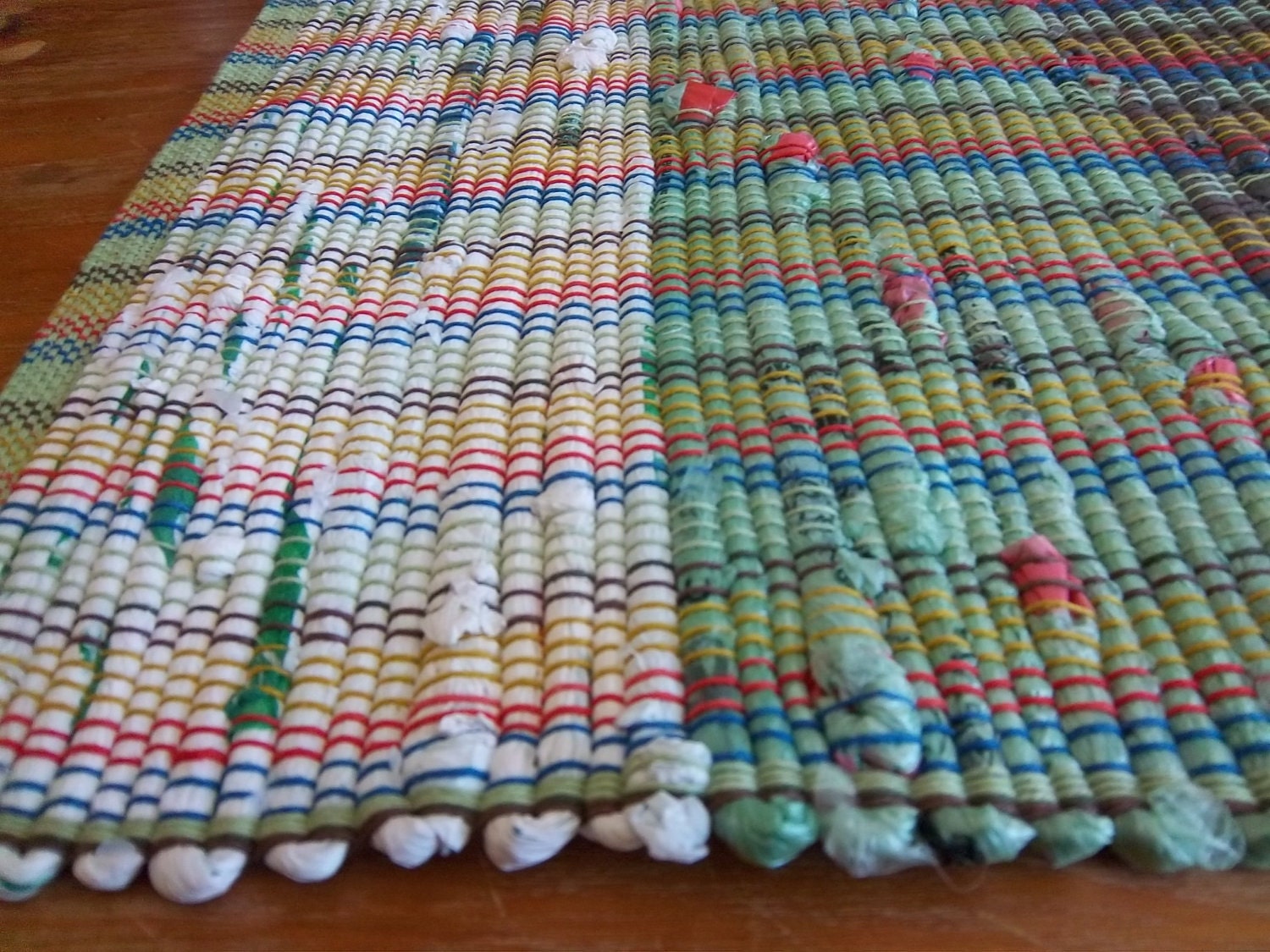 Green Upcycled Rug Woven from Plastic Grocery Bags.