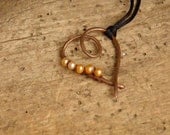 Copper heart necklace with pearls.
