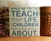 While We Try To Teach Our Children About Life... Painted Wood Sign