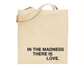 in the madness, there is love tote bag - black text
