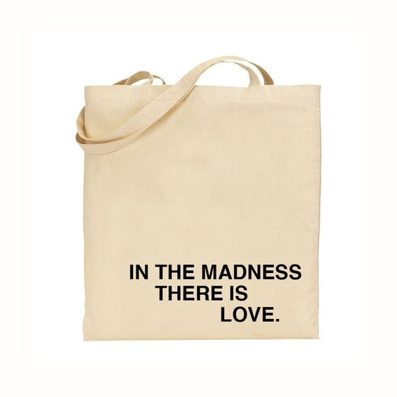 in the madness, there is love tote bag - black text