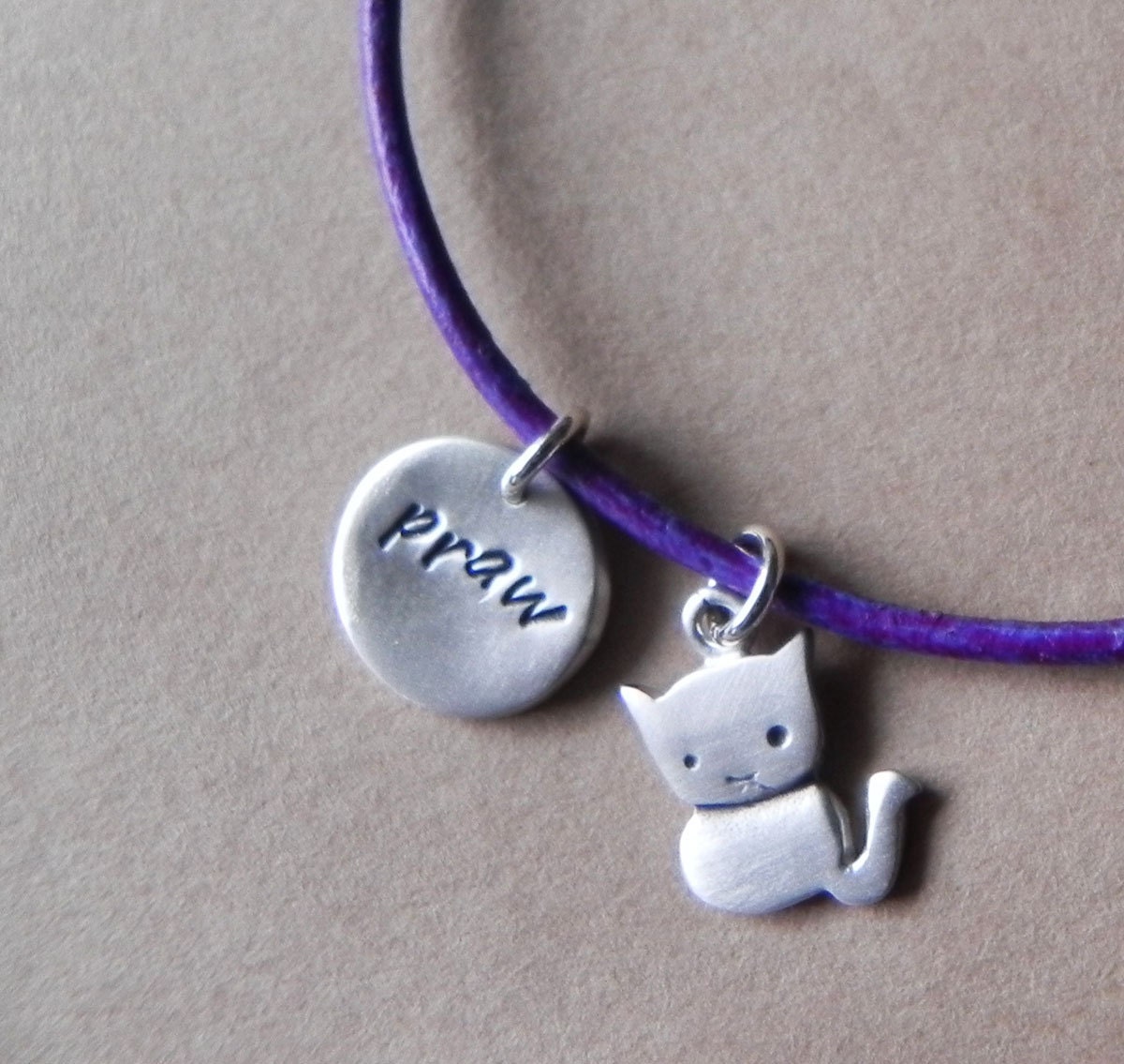 Cute cat sterling silver adjustable personalized bracelet on a washed purple leather cord