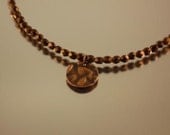 Bronze faceted round necklace with antique copper hammered coin pendant