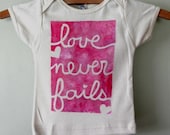 love never fails, hand painted organic cotton baby onesie or children's tee