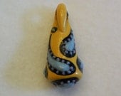 Paisley focal art beadd in porcelain with yellow, blue, purple green and black