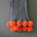 Grey scarf with orange poms
