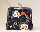 Day of the Dead Palm Clutch in black, pinks, orange, white, green, and blue sugar skulls