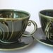 A Pair of Green Stoneware Teacups with Saucers - Wheel thrown