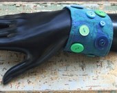 Blue bracelet with blue, teal, and green vintage buttons