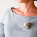 Brooch crocheted balls. Gray and yellow combination.