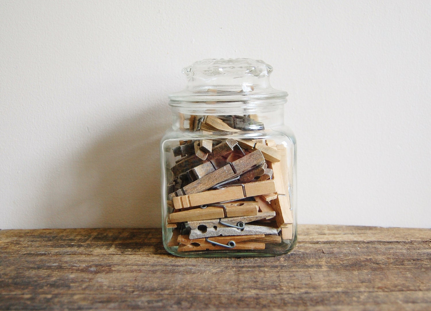 Vintage apothecary jar of clothespins