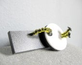 black, white and olive green geometric brooch