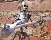 Zombie Skeleton Playing Electric Bass Guitar Metal Sculpture