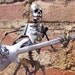 Zombie Skeleton Playing Electric Bass Guitar Metal Sculpture