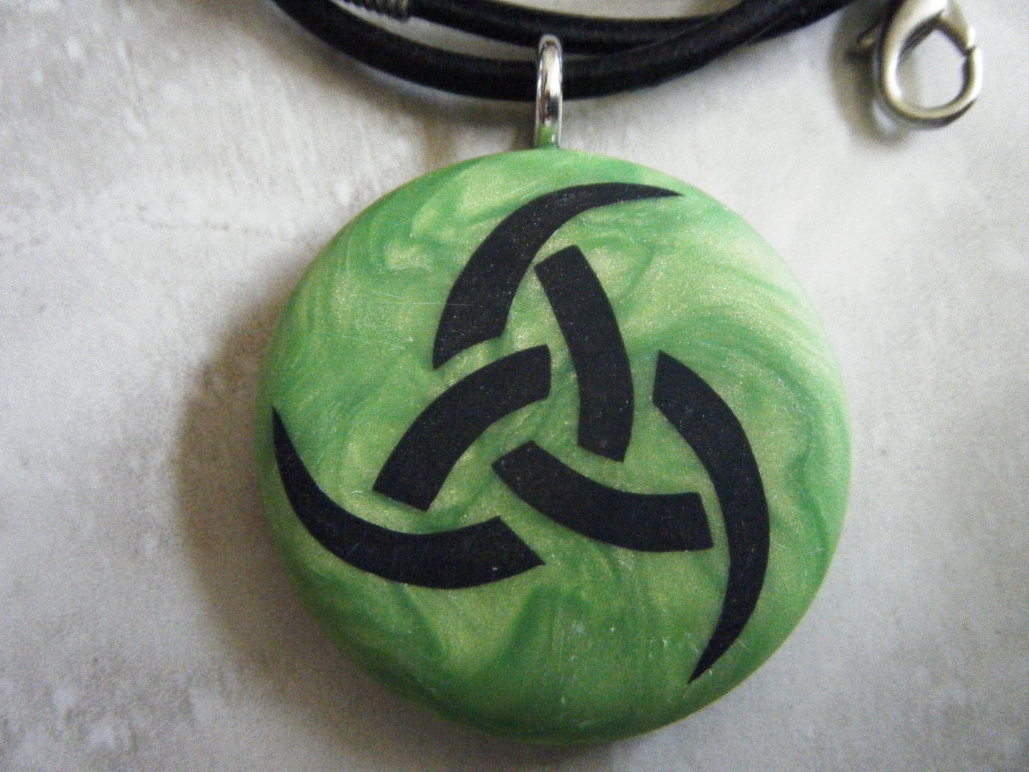 Triple godess hand carved on a green pearl color background. Pendant comes with a FREE 3mm leather necklace