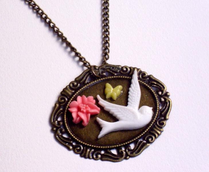 White bird, flower, and butterfly cabochon panel necklace.