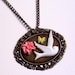 White bird, flower, and butterfly cabochon panel necklace.