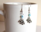 very cute silver baby elephant earrings, with blue crystal bead.